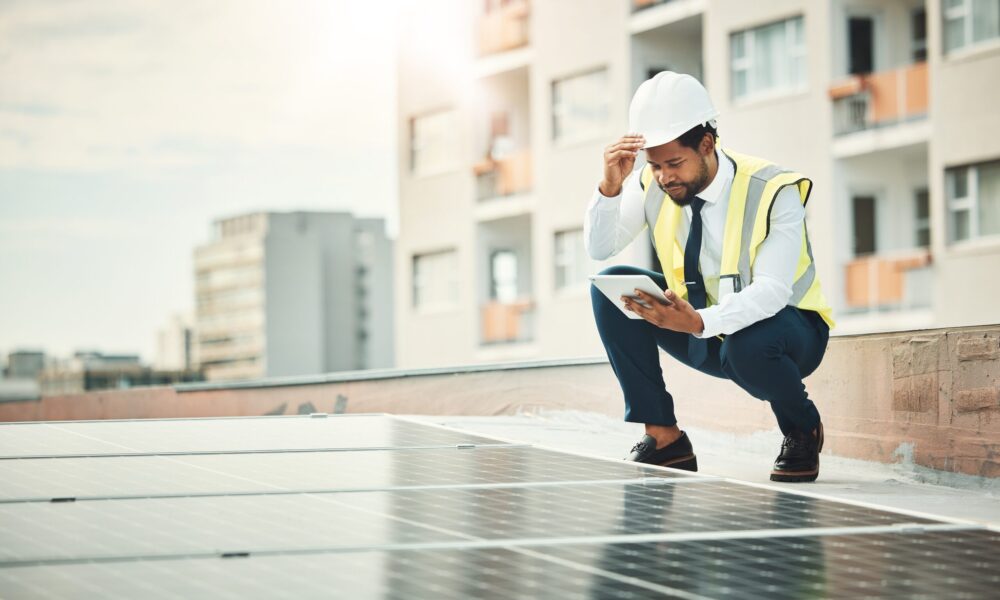 An engineer is inspecting the roof of a house.